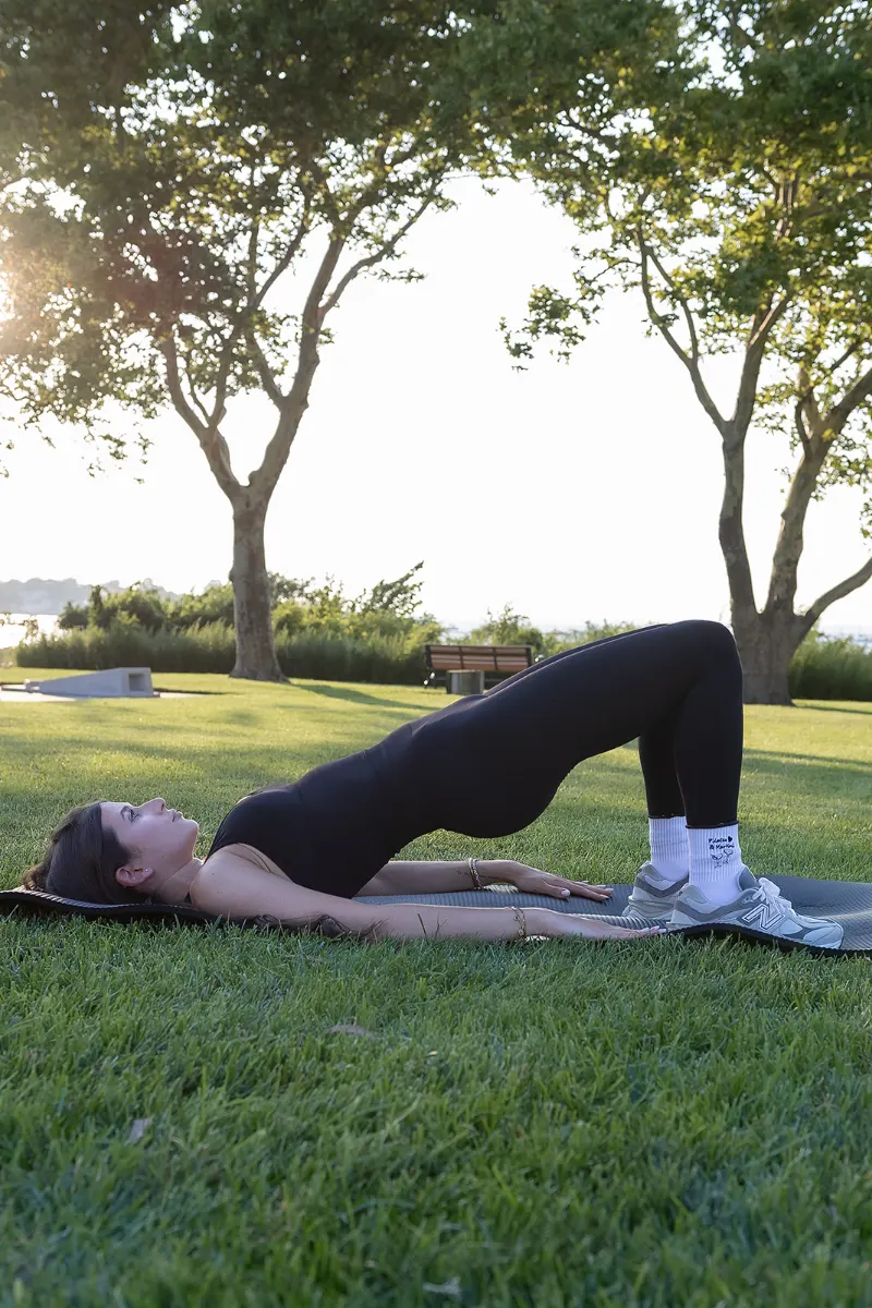 Glute bridge during a Sana Sculpt Pilates session