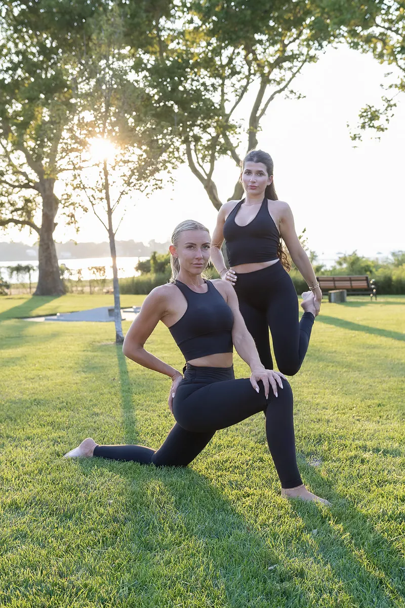 Two students stretching in a kneeling lunge