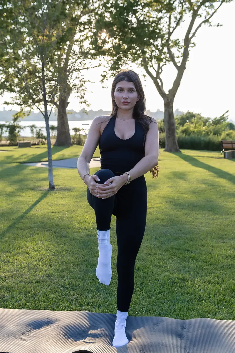 Standing balance with a knee lift during a sculpt class