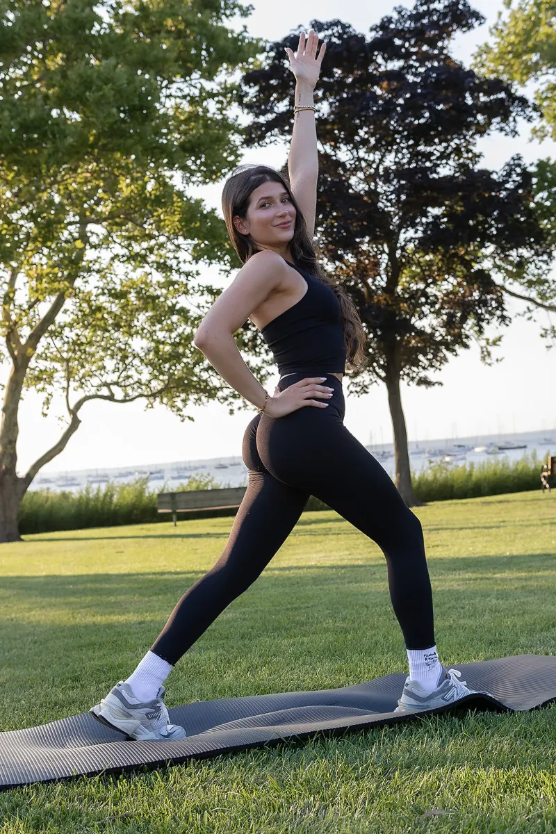 Student reaching overhead in a crescent lunge